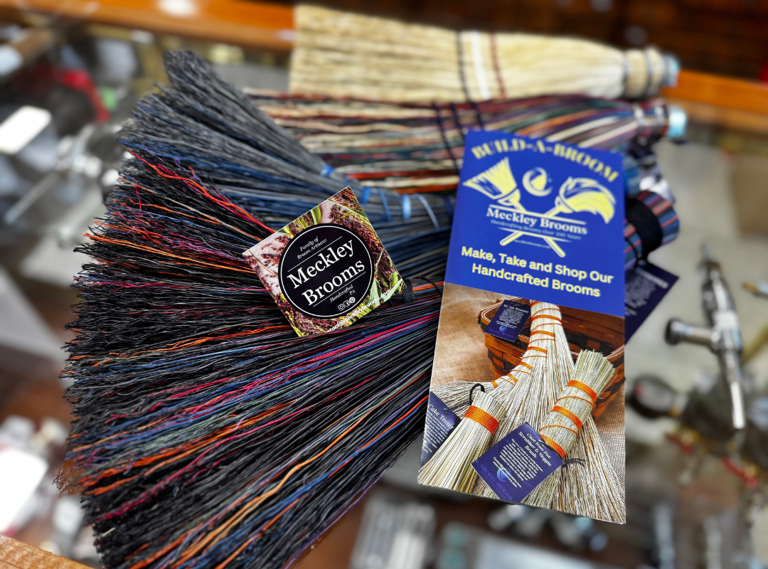 Colorful tassel keychains and a blue product tag displayed on a shop counter