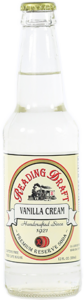 A white bottle labeled “Trading Grounds Vanilla Cream” on a plain white background