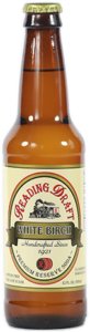 Brown glass bottle of Reading Company White Birch beer with cream label and cap