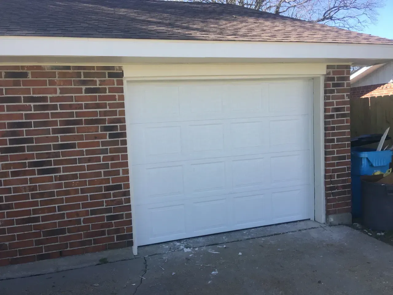 White garage door in a brick building.