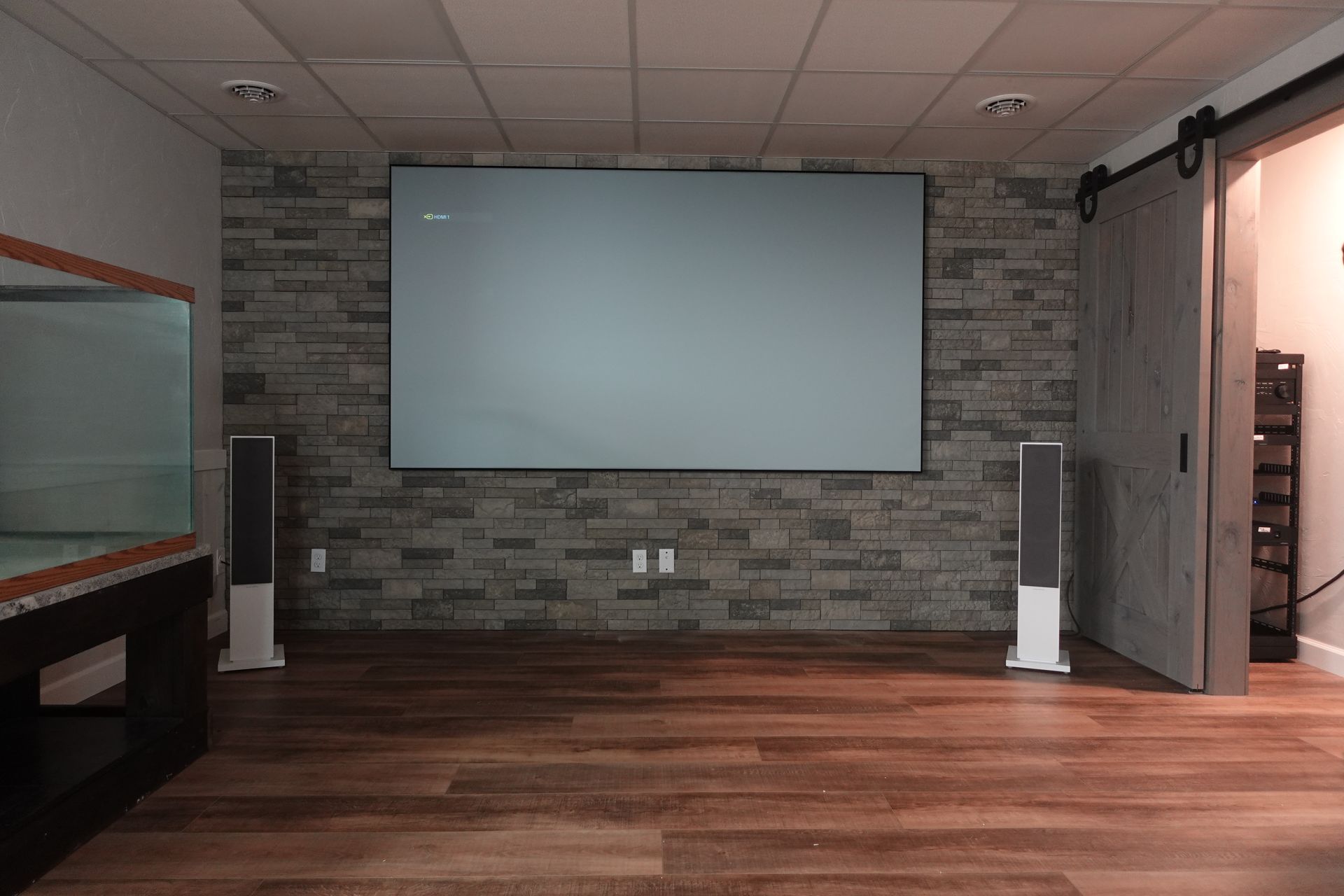 There is a projector screen in the middle of the room.
