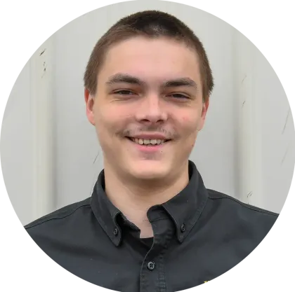 A young man in a black shirt is smiling in a circle