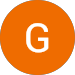 The letter g is in an orange circle on a white background.