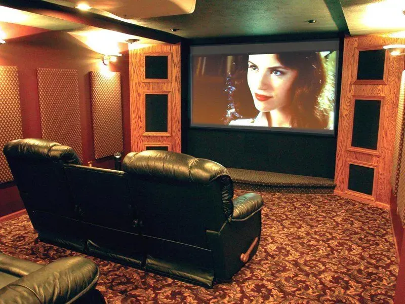 A home theater with a woman on the screen