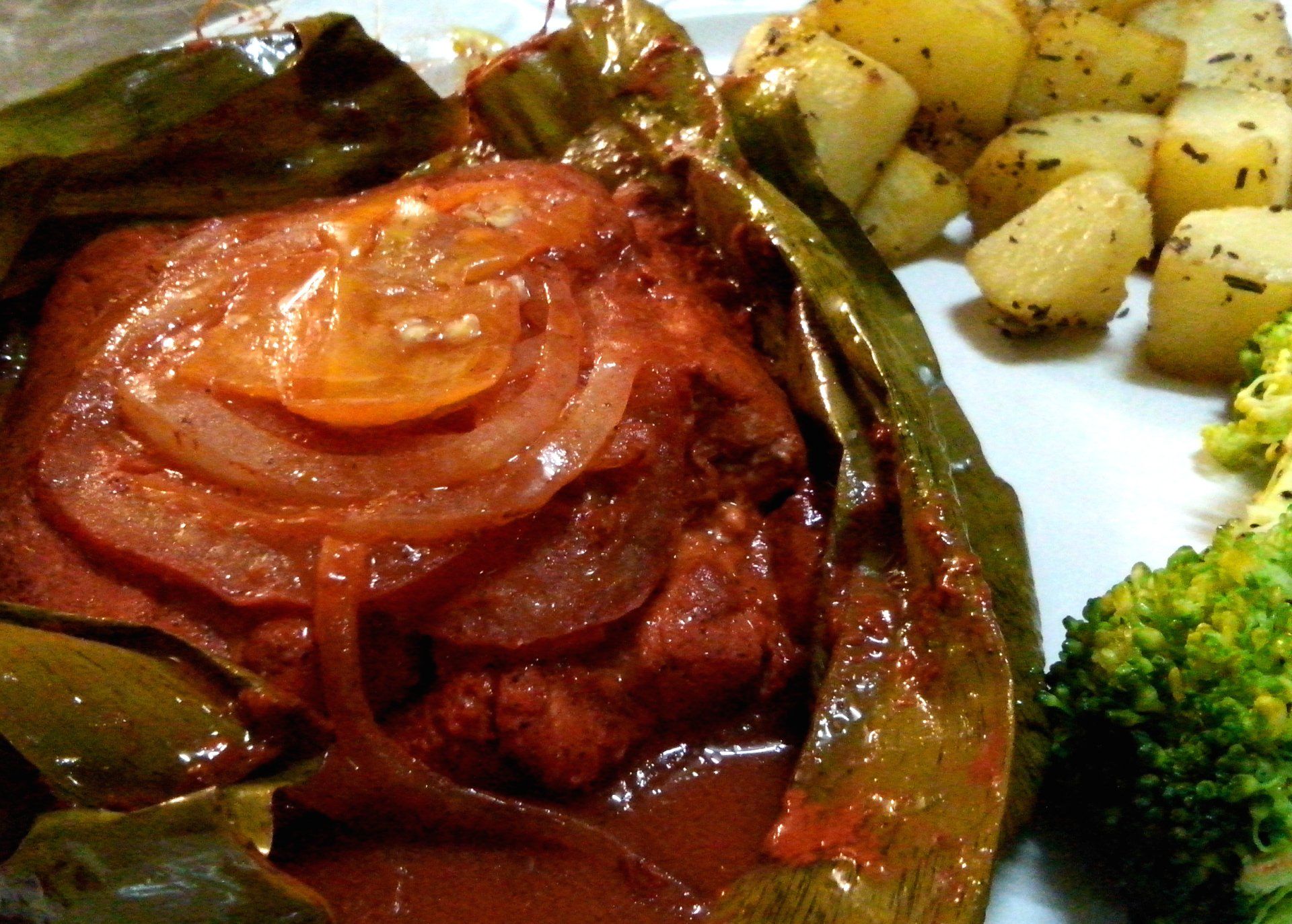 Fish served T'kin xic' style, cooked over flame on a banana leaf