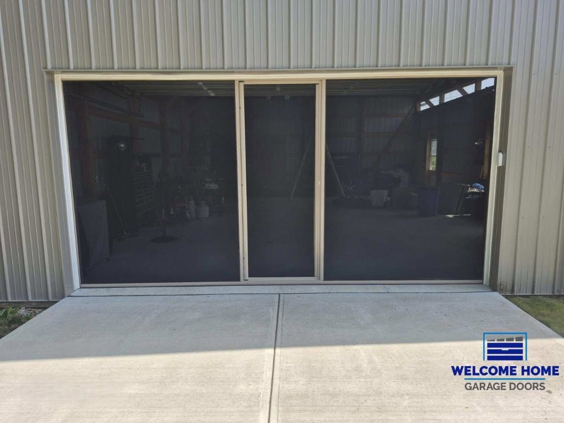 Screened entrance with double glass doors and a welcome home sign beside the walkway.
