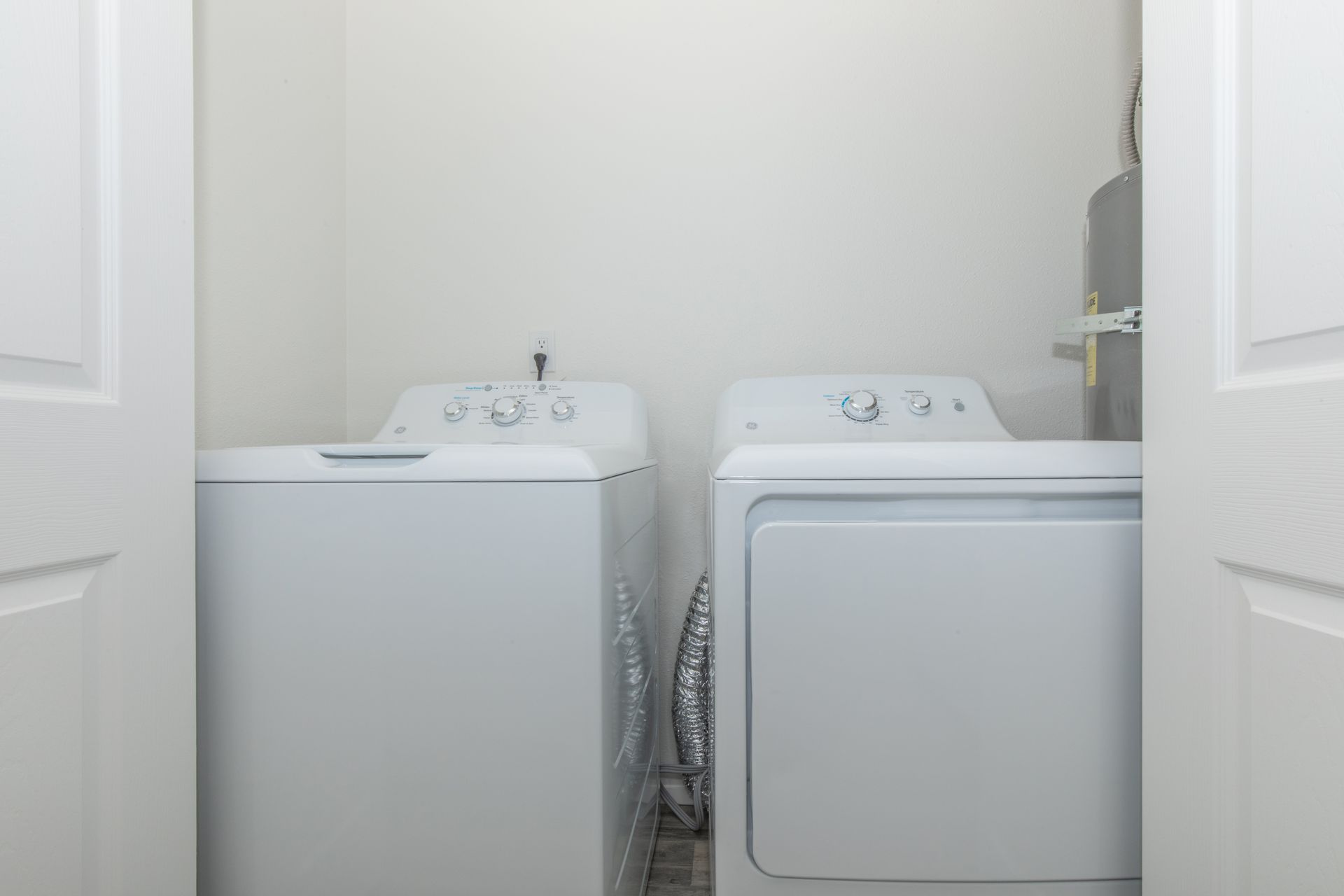 A laundry room with a washer and dryer in it.