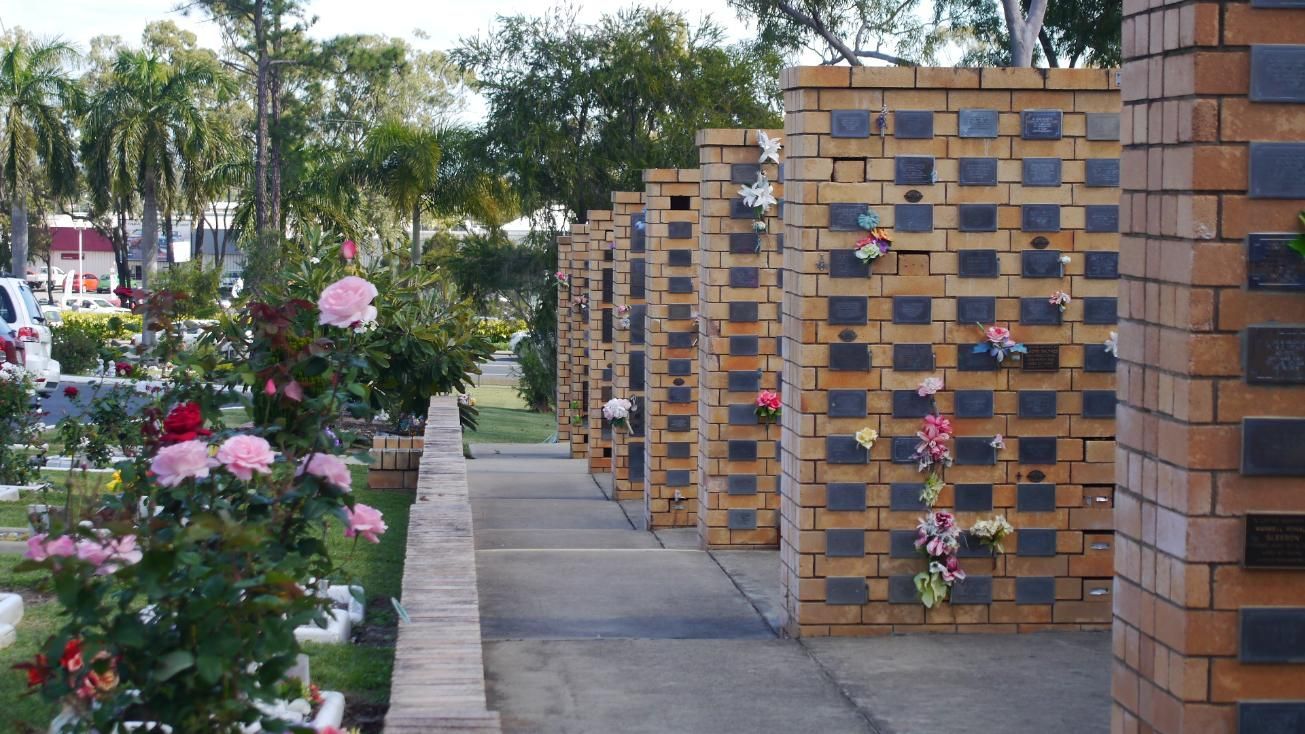 Row of Brick Columbarium Niches in A Cemetery, Adorned with Flowers — Rockhampton Crematorium in Norman Gardens, QLD