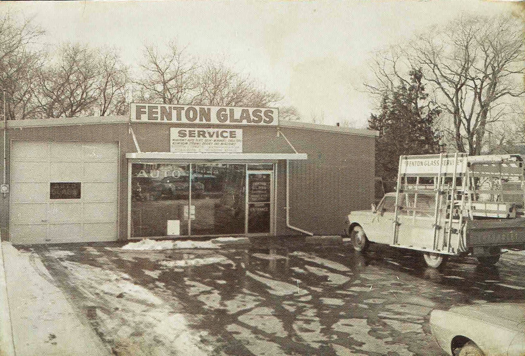A black and white photo of a glass shop.