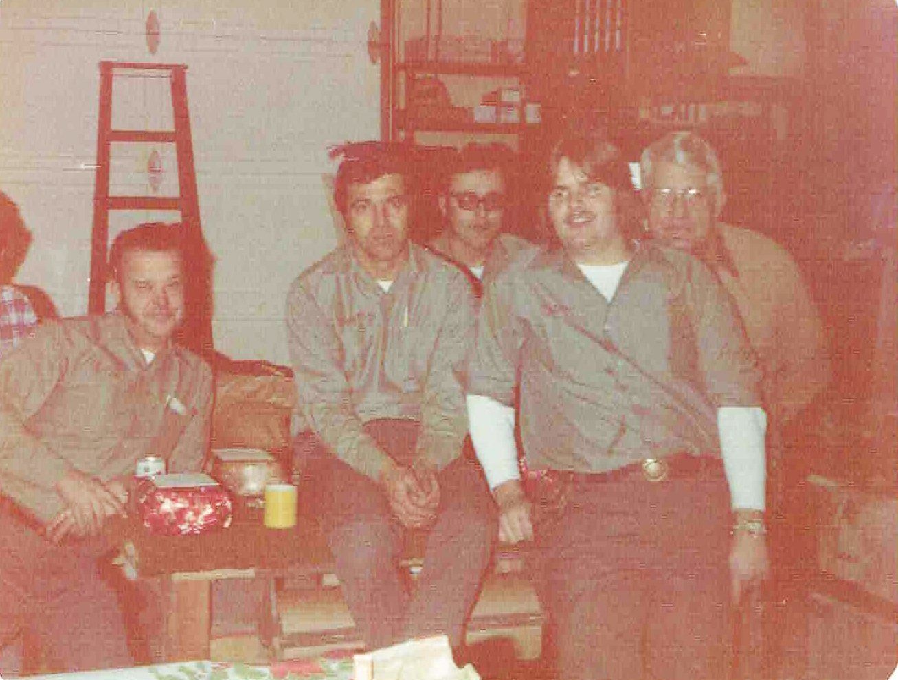 A group of men are posing for a picture in a room.