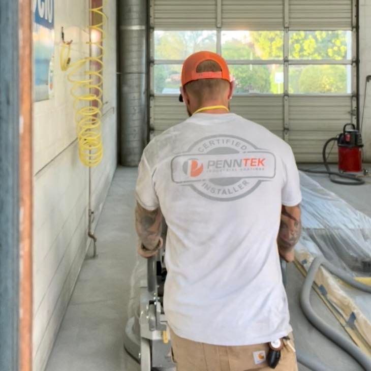 Technician smoothing out concrete floor