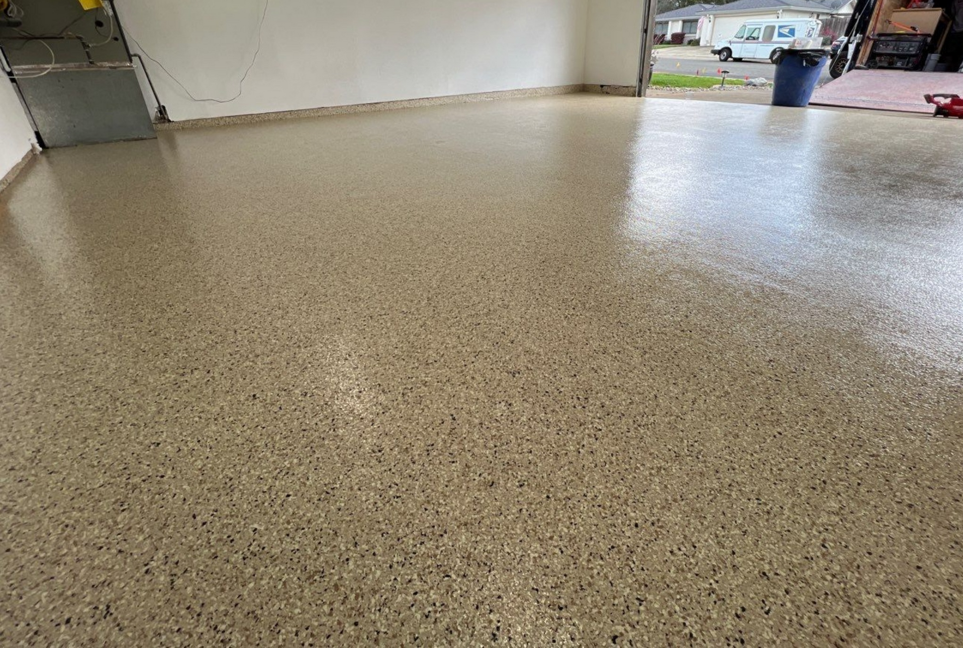 A garage floor with a lot of small stones on it.