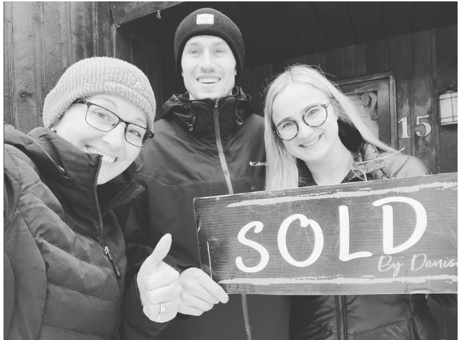 Three people smiling and holding a