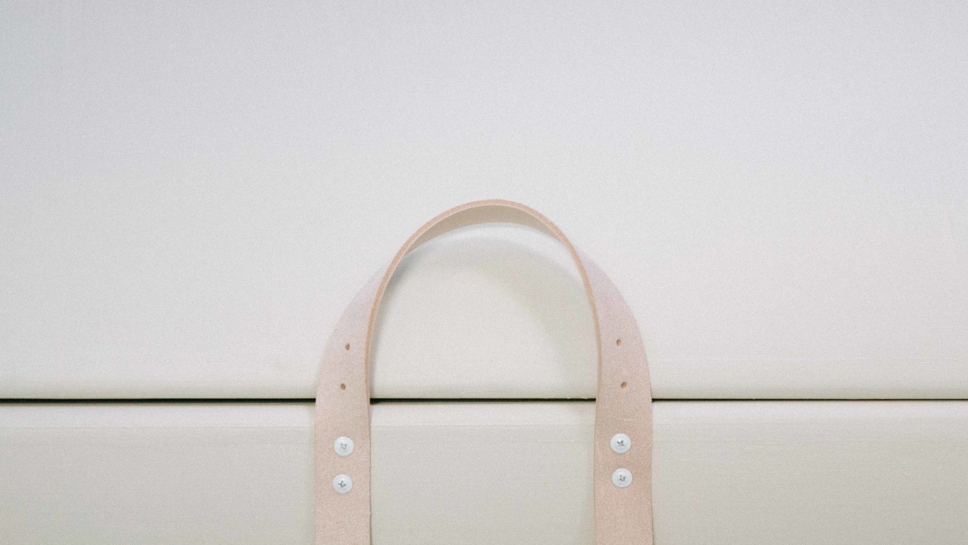 A close up of the natural leather handles of the PeacePod casket coffin.