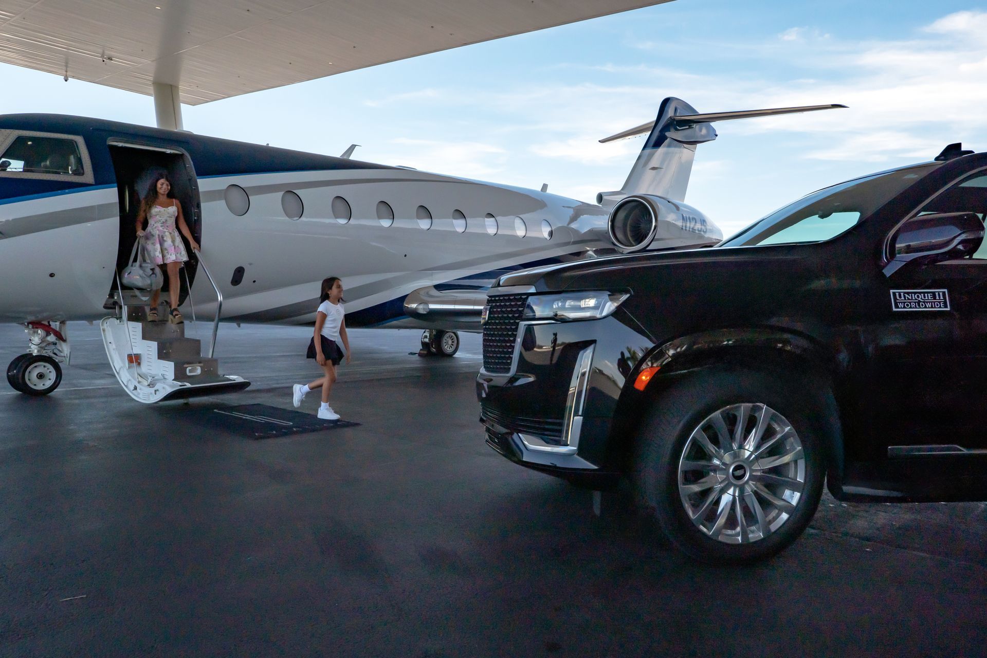 A Woman Is Getting Off a Private Jet Next to A Car. - Teterboro, NJ - Unique II Worldwide