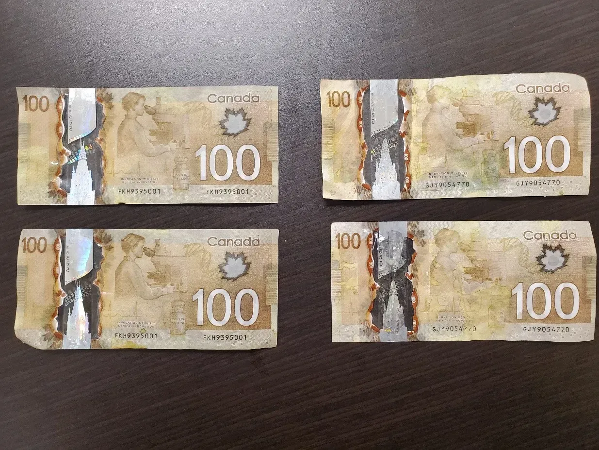 Cobourg police are investigating the use of counterfeit $100 bills at businesses. Cobourg Police Service Four canadian 100 dollar bills are sitting on a table.