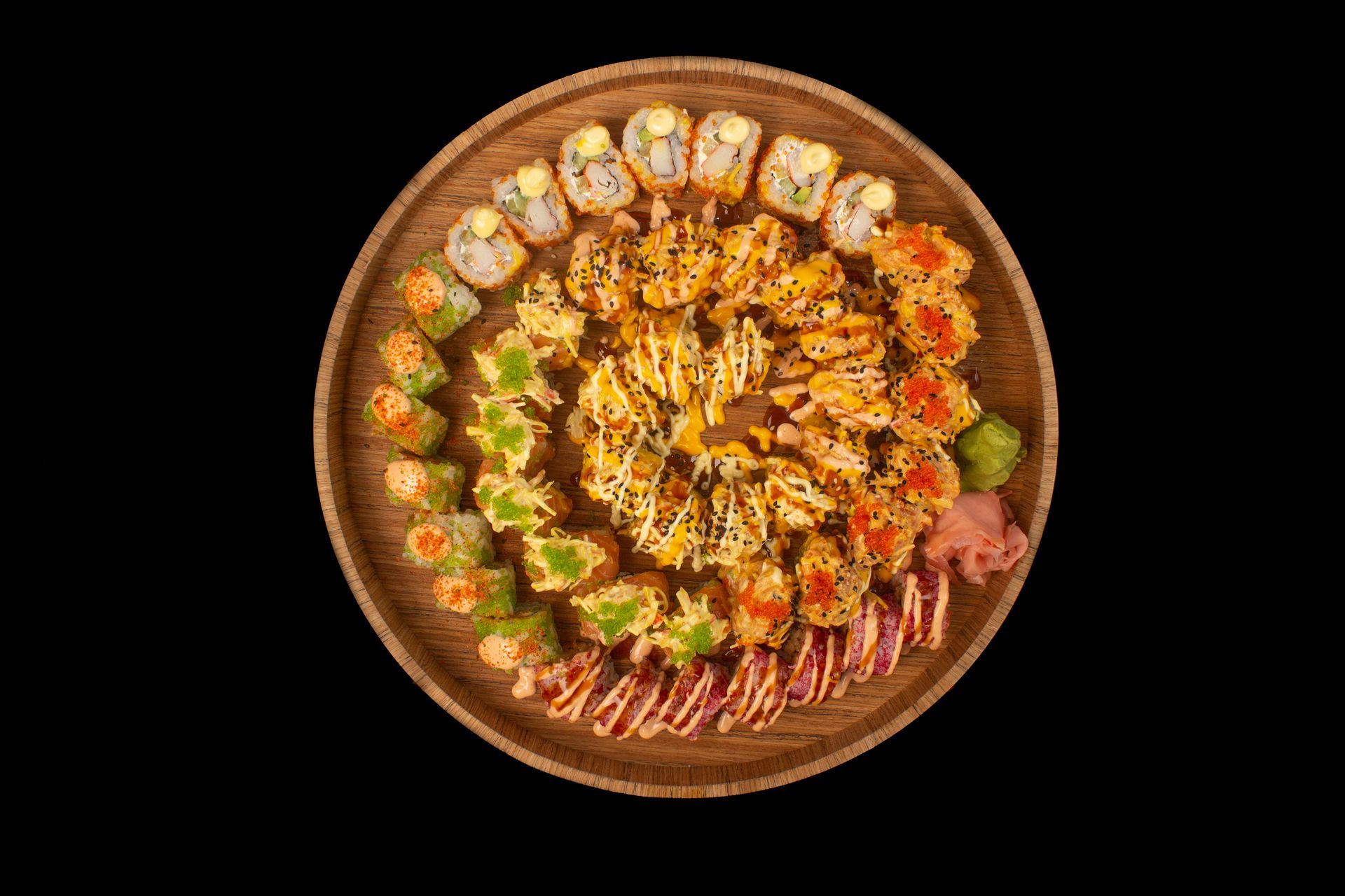 Sushi Restaurant | Finding Sushi | Top-down view of a round platter with assorted sushi arranged 