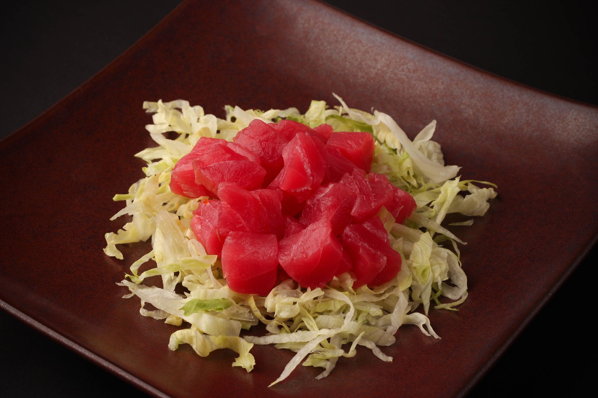 Sushi Restaurant | Finding Sushi | Diced red tuna on shredded cabbage in a dark square bowl
