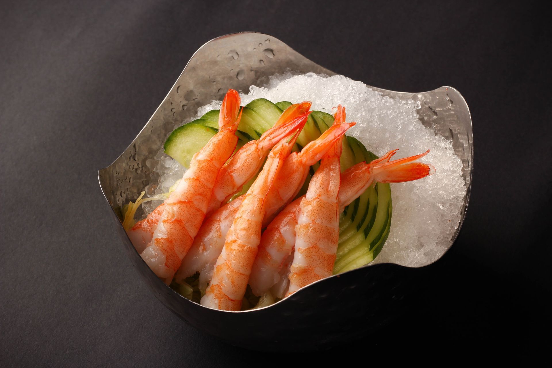 Sushi Restaurant | Finding Sushi | Shrimp sashimi on sliced cucumber in a scalloped shell bowl