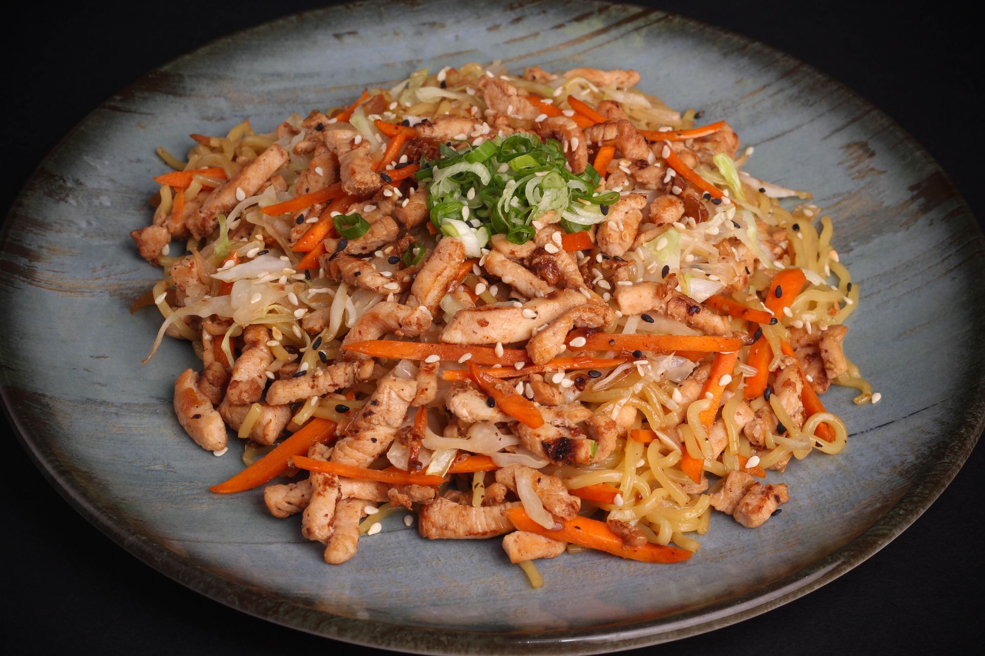 Sushi Restaurant | Finding Sushi | Stir-fried noodles with chicken and vegetables, topped with chopped green onions.