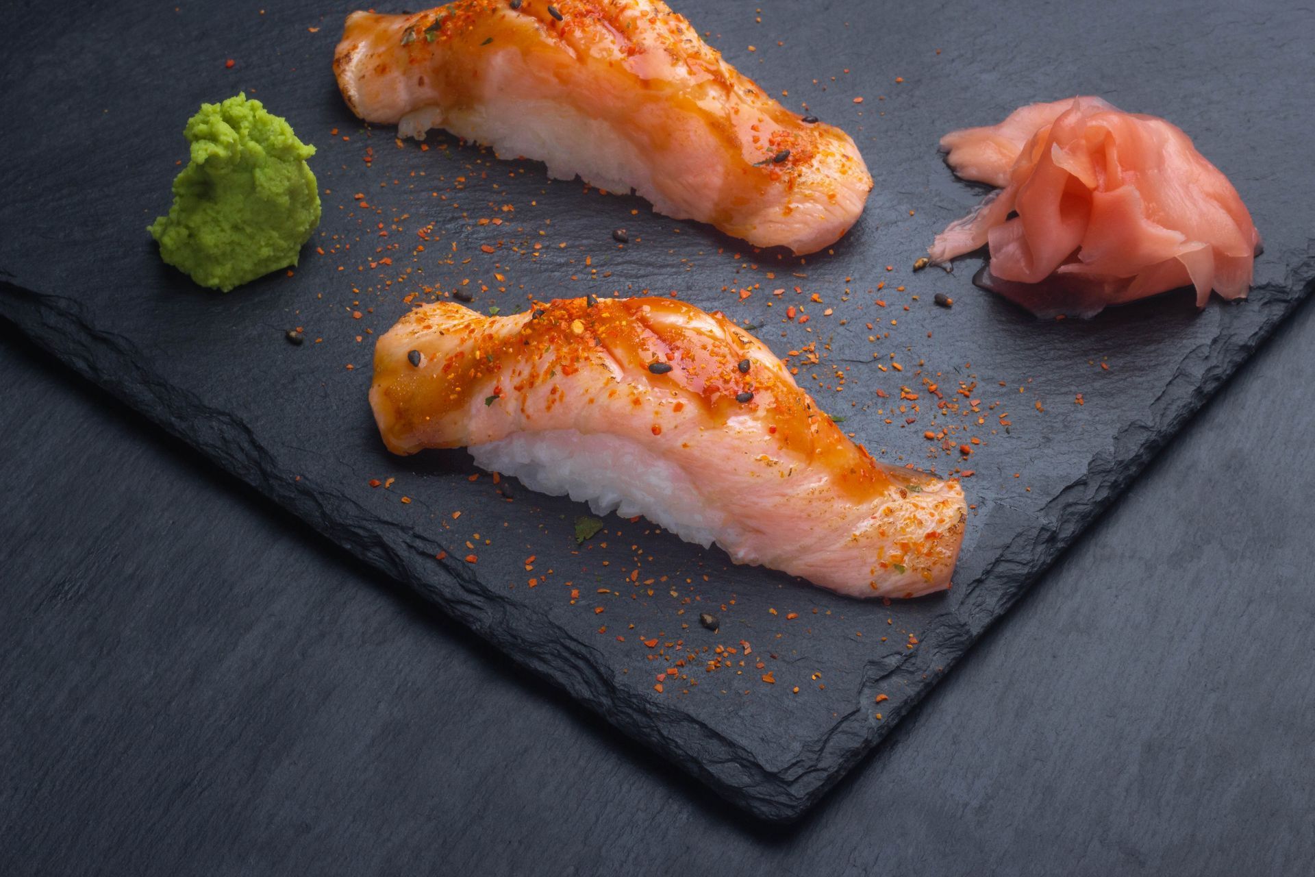 Sushi Restaurant | Finding Sushi | Sushi pieces on a dark slate plate with wasabi and pickled ginger