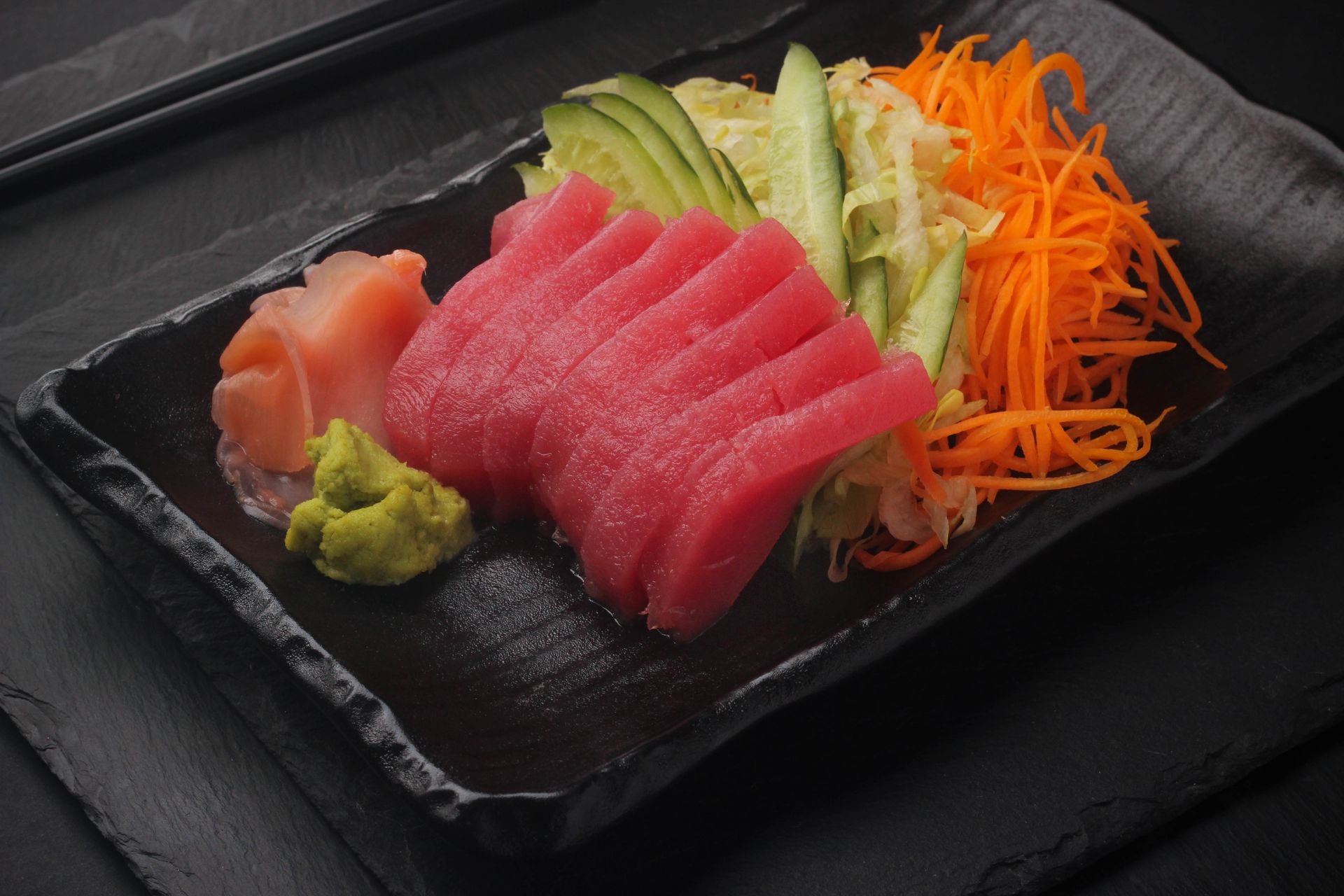 Sushi Restaurant | Finding Sushi | Tuna Assorted sashimi on a black rectangular plate with wasabi