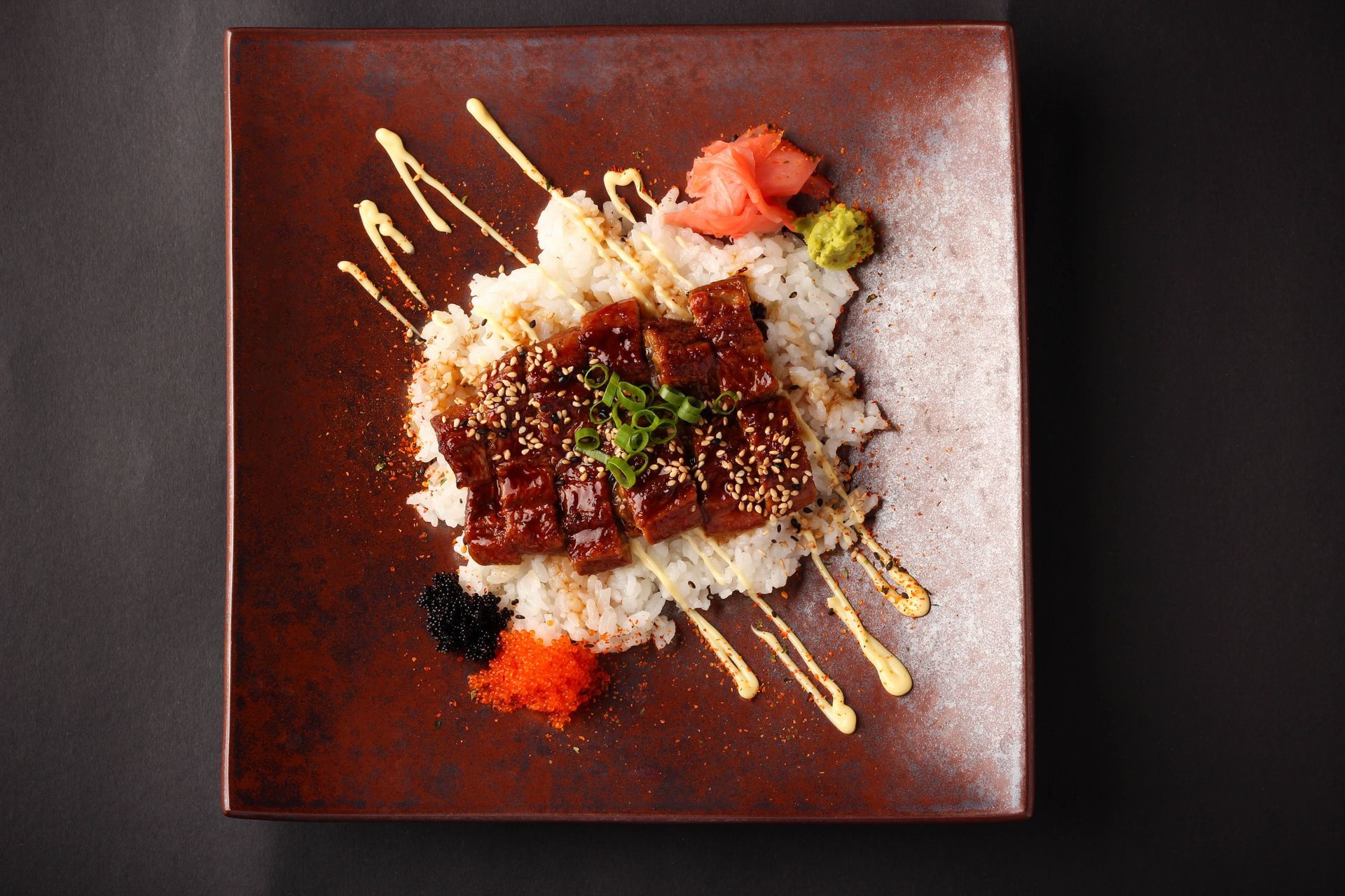 Sushi Restaurant | Finding Sushi | Square plate with a rice-topped meat dish, 