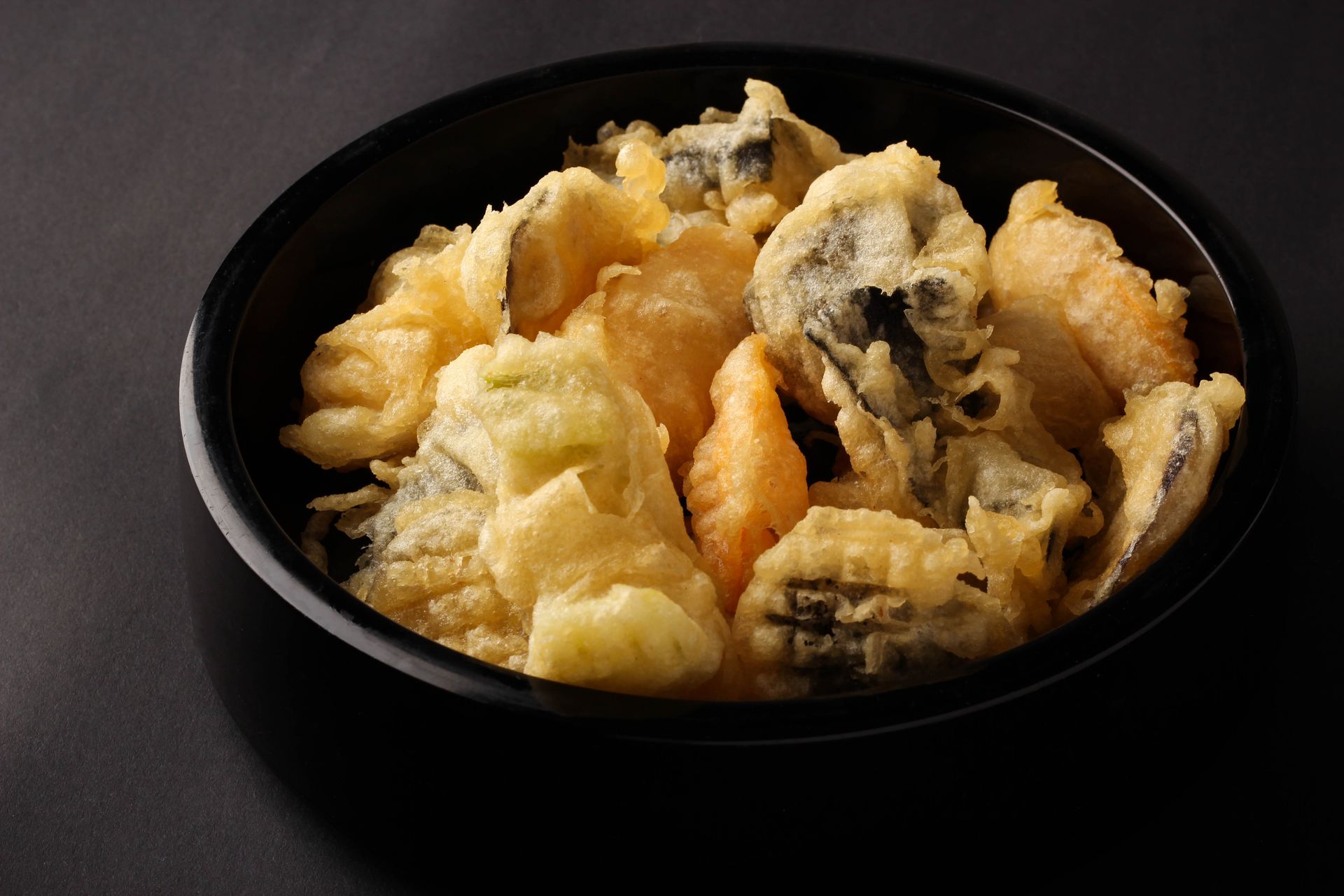 Sushi Restaurant | Finding Sushi | Bowl of assorted golden tempura pieces, some with dark mushroom slices