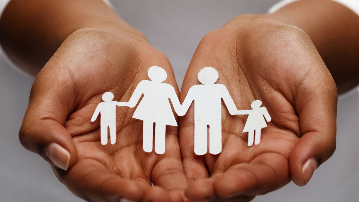 A man and woman are holding a baby and two children.
