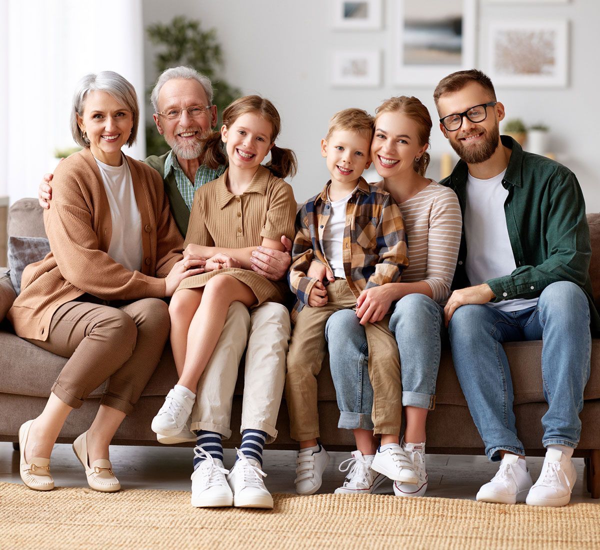 Family Sitting Together on Couch — Hampton, NH — Hampton Bay Insurance Agency Family Sitting Together on Couch — Hampton, NH — Hampton Bay Insurance Agency
