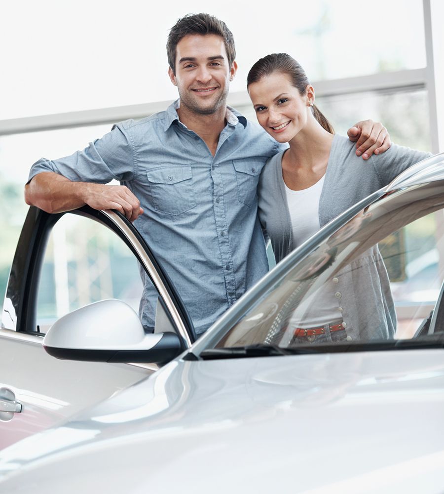 Couple Standing Alongside Their Dream Vehicle — Hampton, NH — Hampton Bay Insurance Agency Couple Standing Alongside Their Dream Vehicle — Hampton, NH — Hampton Bay Insurance Agency