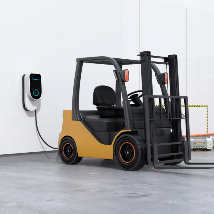 Electric forklift charging next to a wall
