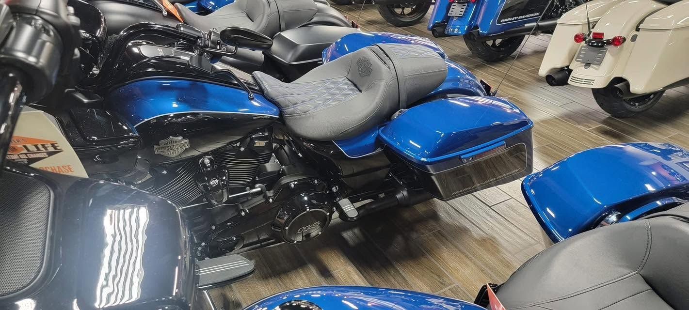 Blue-and-black motorcycles parked tightly together in an indoor showroom