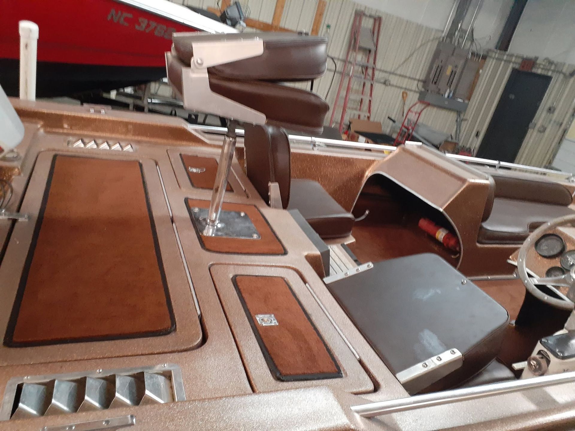 Brown boat cabin with dashboard, controls, and seats inside a yacht interior