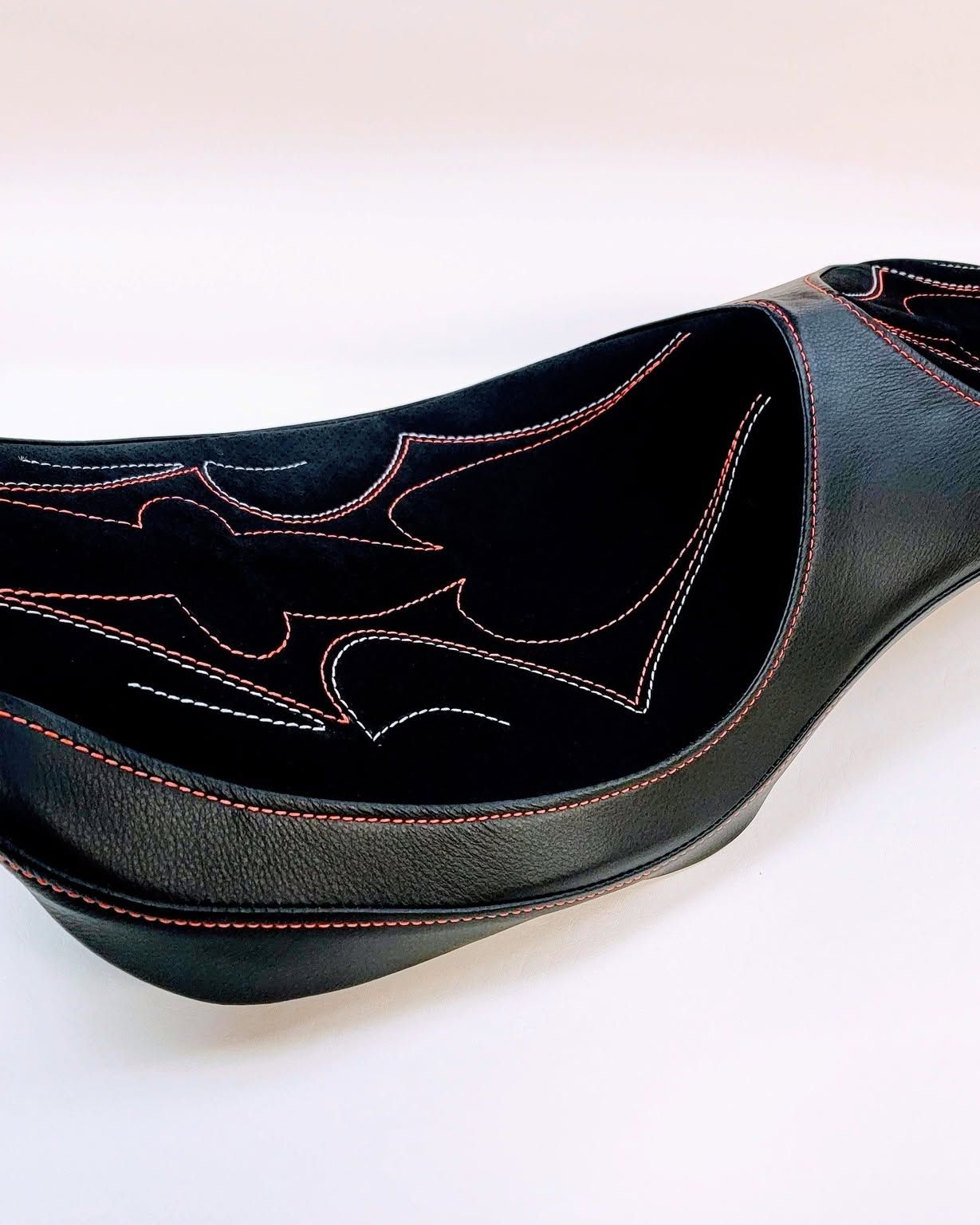 Black embroidered slip-on shoe on a white background