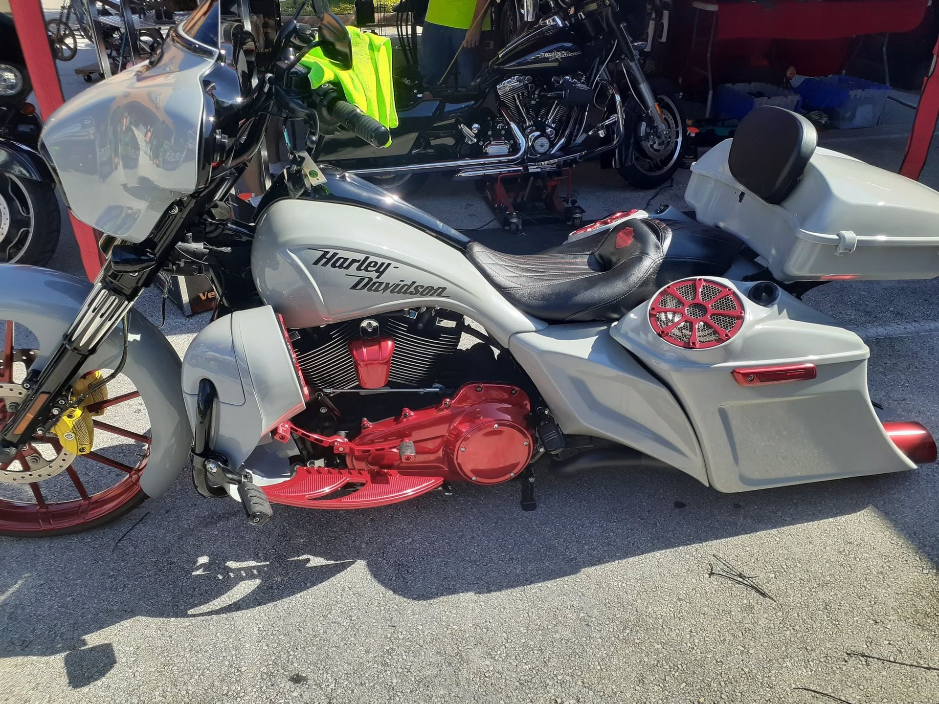 Custom white and red motorcycle parked outdoors among other bikes