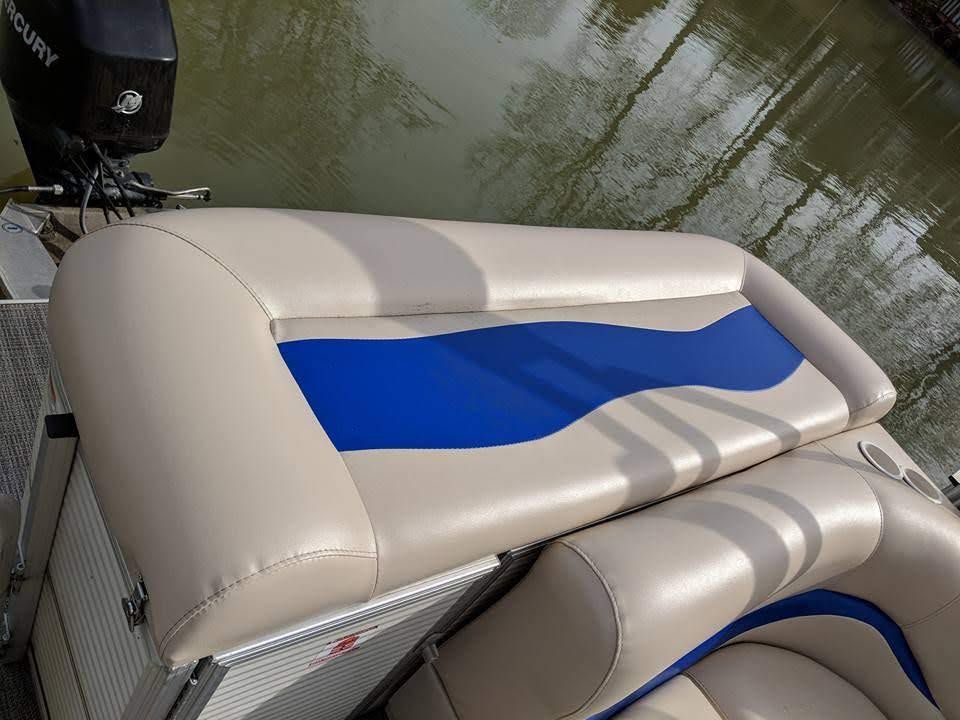 Beige and blue boat seat upholstery beside water