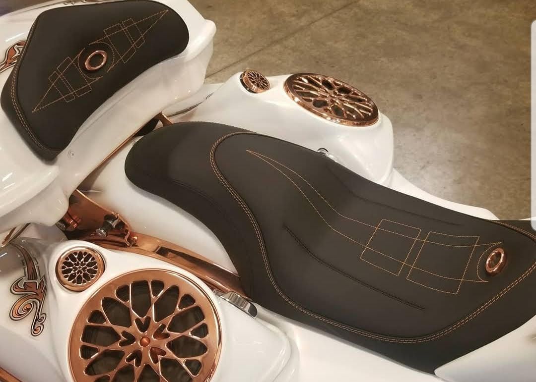 Black and white fashion shoes with rose-gold decorative patterns on a neutral floor