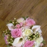 Pink and white rose bouquet on a wooden floor