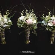 Three white and pink floral bouquets on a black background