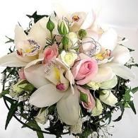 White and pink floral bouquet with lilies, roses, and greenery