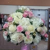 Large bouquet of white and pink roses in a glass vase indoors
