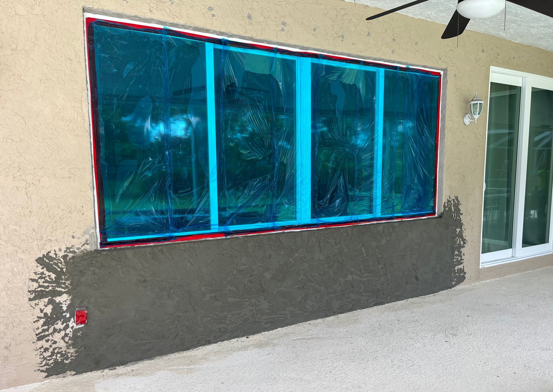 A large window is being installed on the side of a building.