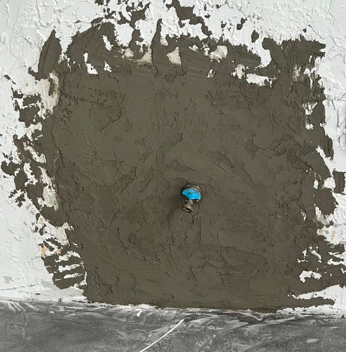 A person is standing in the middle of a pile of concrete.