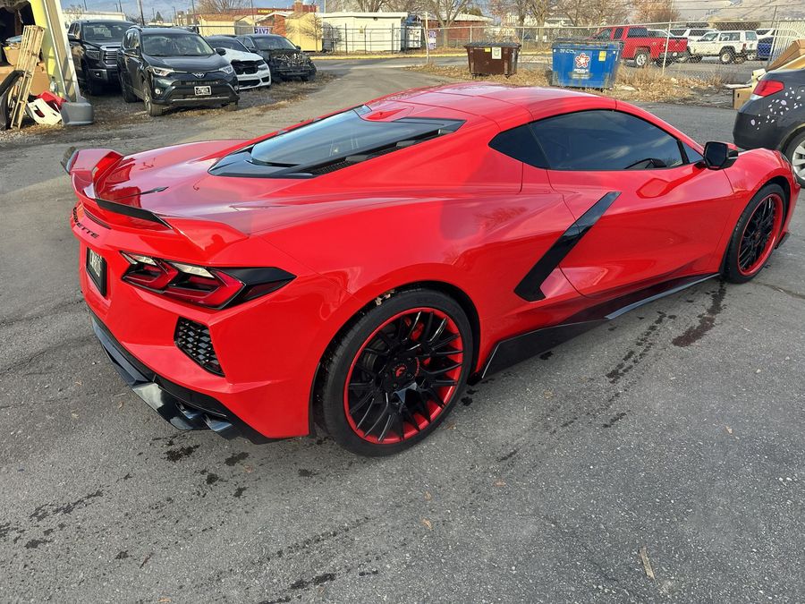 Red Chevy Corvette car with black accents parked on a lot
