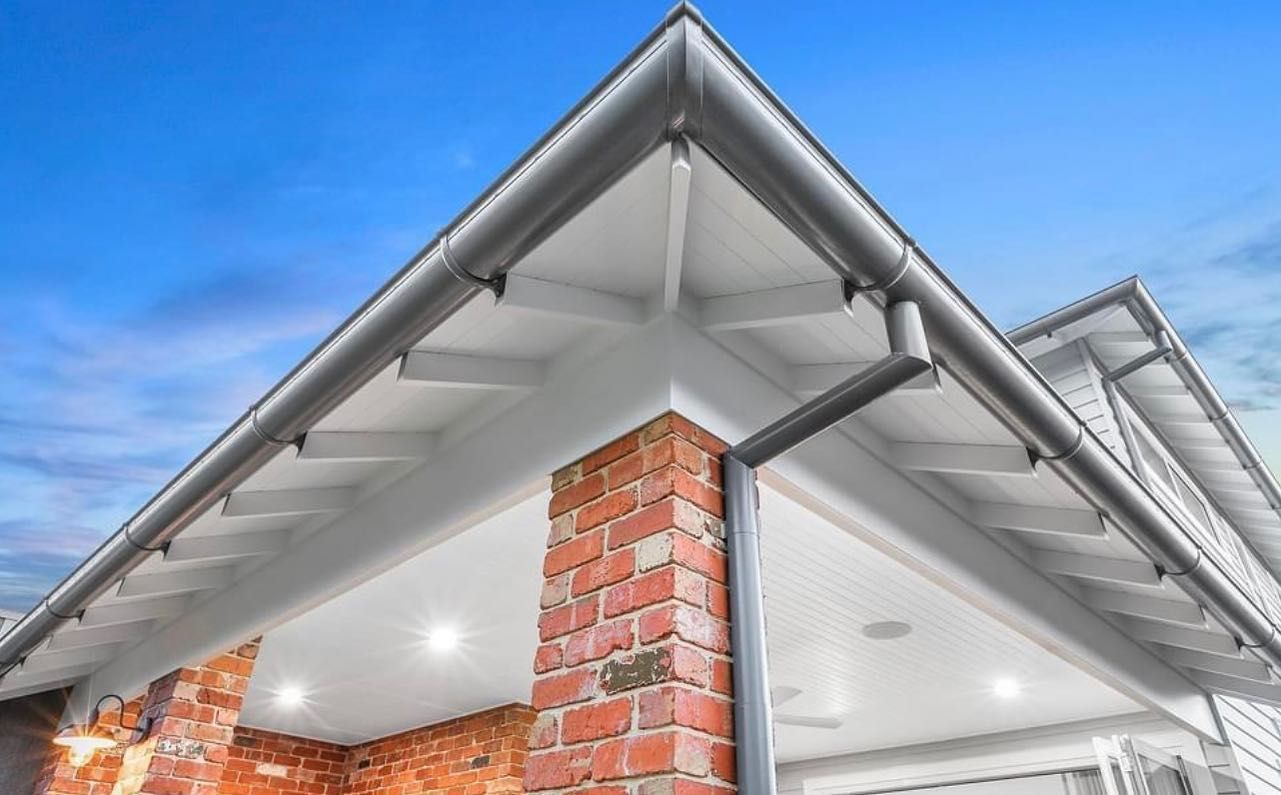 The Roof of a House With a Brick Chimney and Gutters — Goulburn Roofing In Mittagong, NSW