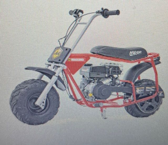 Red mini motorbike with fat tires and high handlebars on a white background
