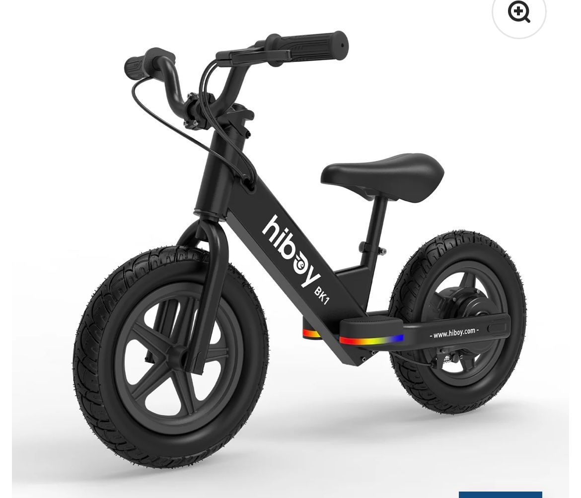 Black electric balance bike with thick tires and low seat on a white background
