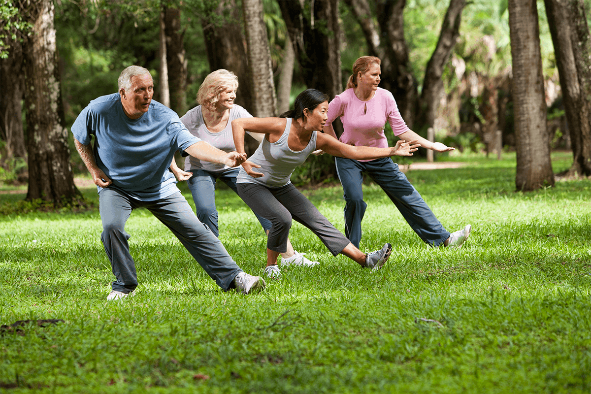 A group of people are playing frisbee in a park.