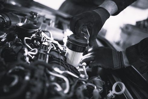 Mechanic hands installing an air filter in a car engine bay: mechanical service in Maitland